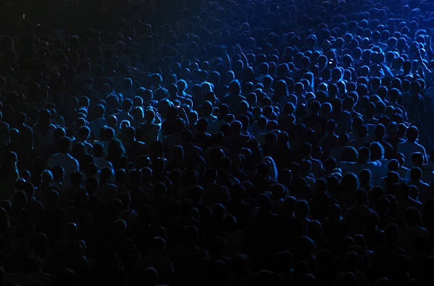 Cheering crowd at the rock concert in a concert hall