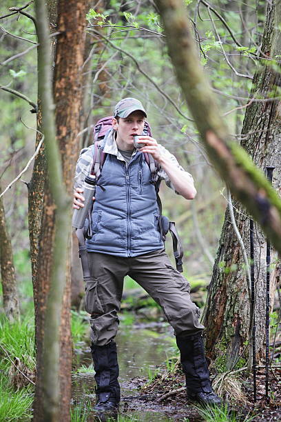 istock hiker having break for  cup of tea in forest 450423569