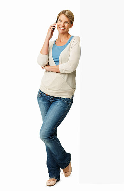 istock Woman Answering Smart Phone While Leaning On Blank Billboard 450435655