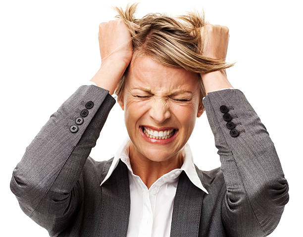 Frustrated Businesswoman Tearing Out Hair Frustrated businesswoman tearing out hair against white background. Horizontal shot. clenching teeth stock pictures, royalty-free photos & images