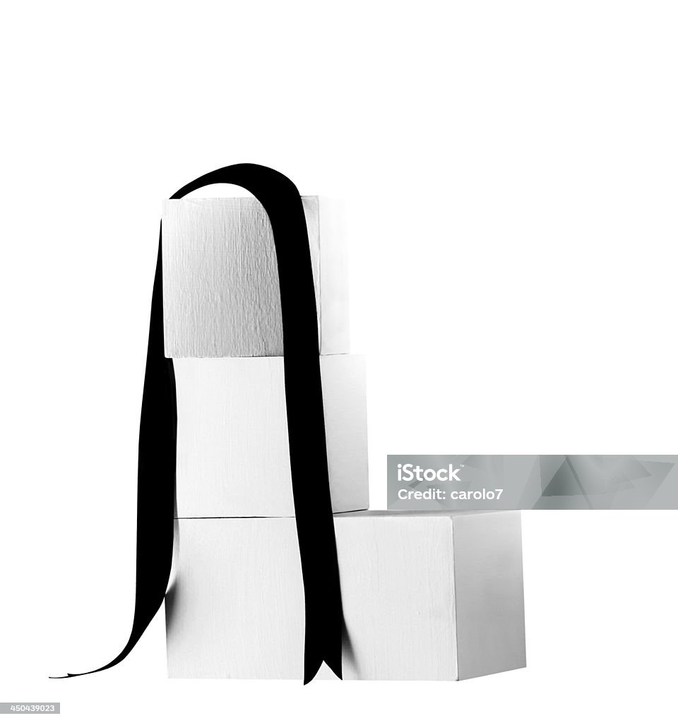 Four white wood blocks, black ribbon.  Clipping path.  Copy space. Black and white image.  Blank space on blocks.  Clipping path on blocks and ribbon. Arrangement Stock Photo