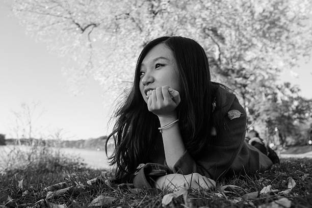 istock Woman laying on grass 450445759