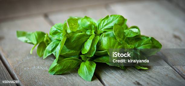 Basil Leaves On A Wooden Table Stock Photo - Download Image Now - Basil, Bowl, Cooking