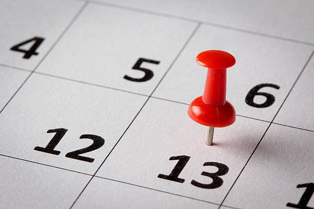 istock Day on calendar marked with a red thumbtack 450446419