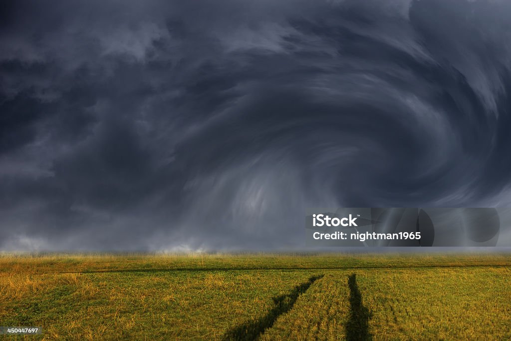 Storm clouds over field Storm dark clouds over field - dramatic sky. Agricultural Field Stock Photo