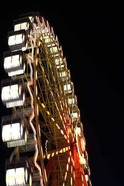 Nightly ferris wheel Ferris wheel at the "Hamburger Dom". gyration stock pictures, royalty-free photos & images