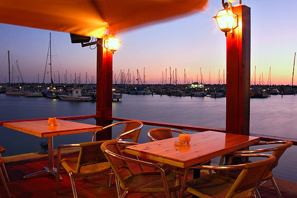 istock Outdoor restaurant on marina at evening. 450453385