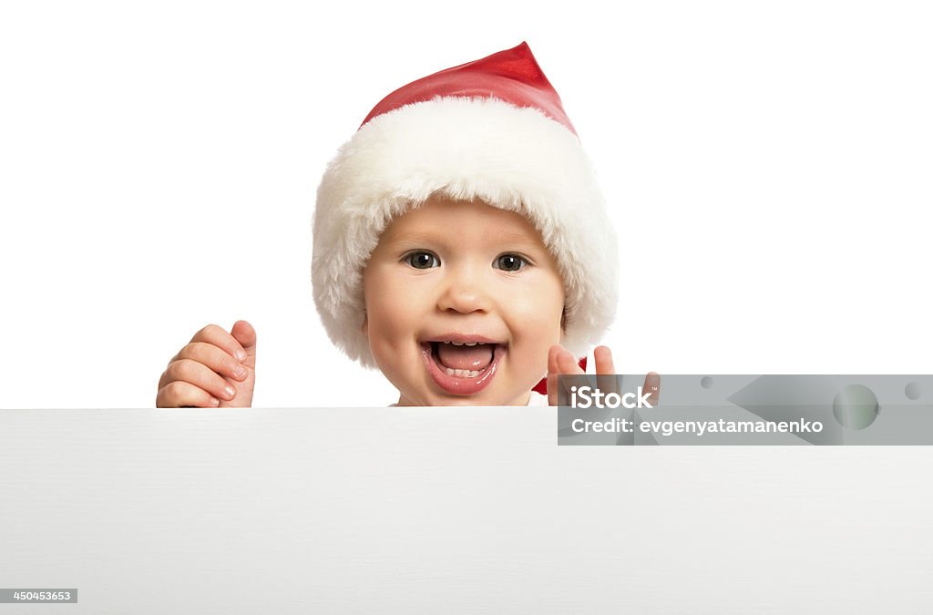 Счастливый ребенок в Рождество hat и пустой рекламный щит изолированные - Стоковые фото Афиша роялти-фри
