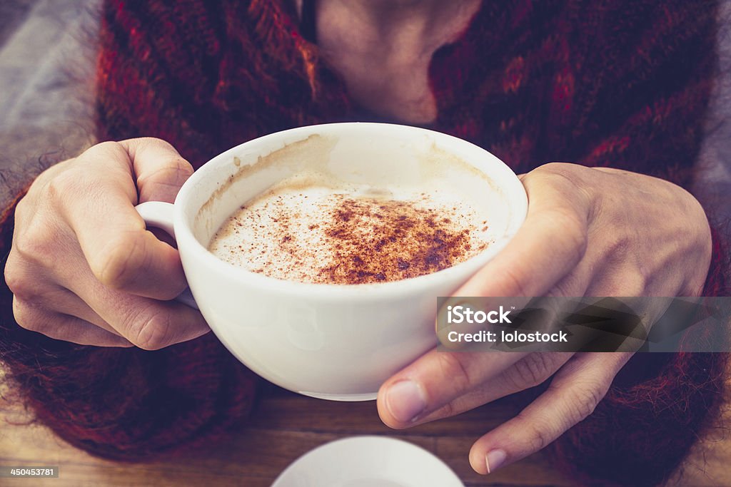Woman in wool jumper drinking coffee on cold day Close up on young woman in wool jumper drinking coffee on a cold day Adult Stock Photo