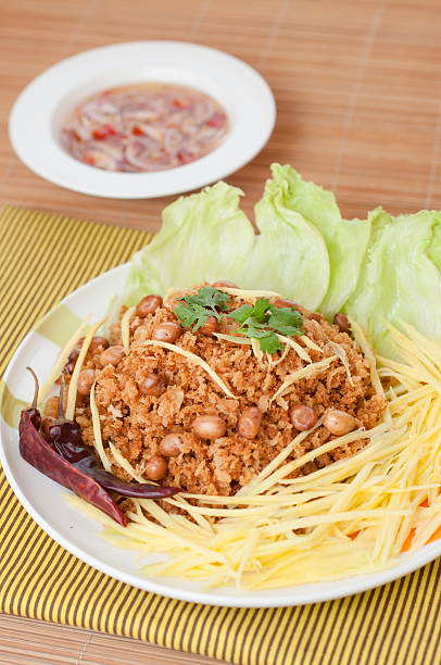 Crispy catfish with green mango salad, popular food in Thailand. stock photo