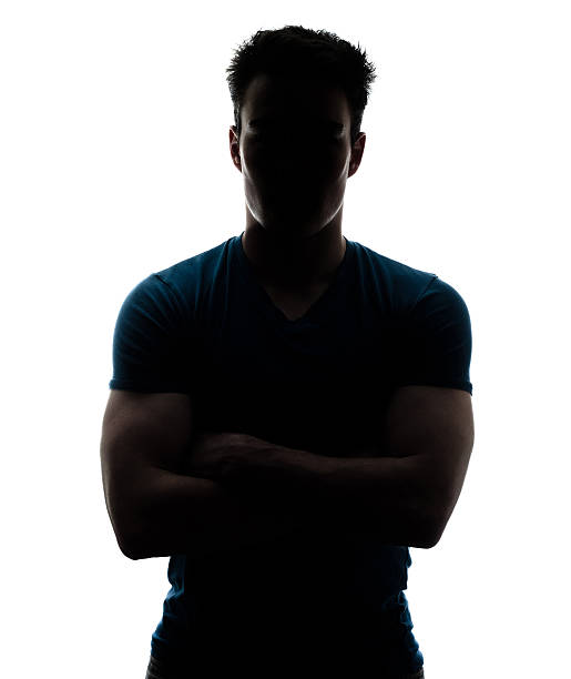 Male figure in silhouette looking at the camera stock photo