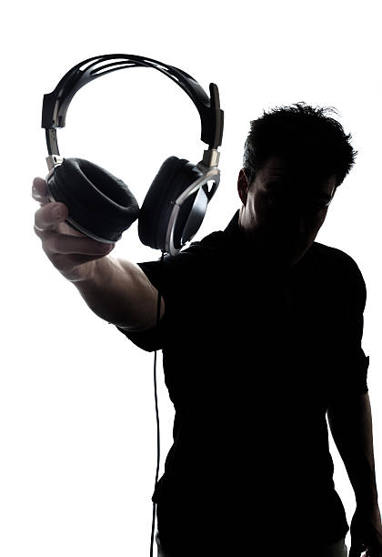 istock Male in silhouette showing headphones 450468863