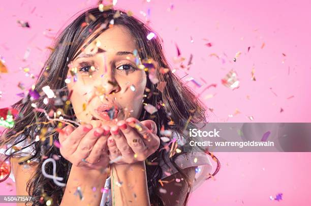 Woman Blowing Colourful Confetti Stock Photo - Download Image Now - Women, New Year's Eve, Celebration