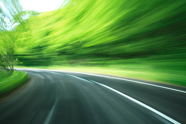road モーションブラーでの緑の森 - car green nature landscape ストックフォトと画像