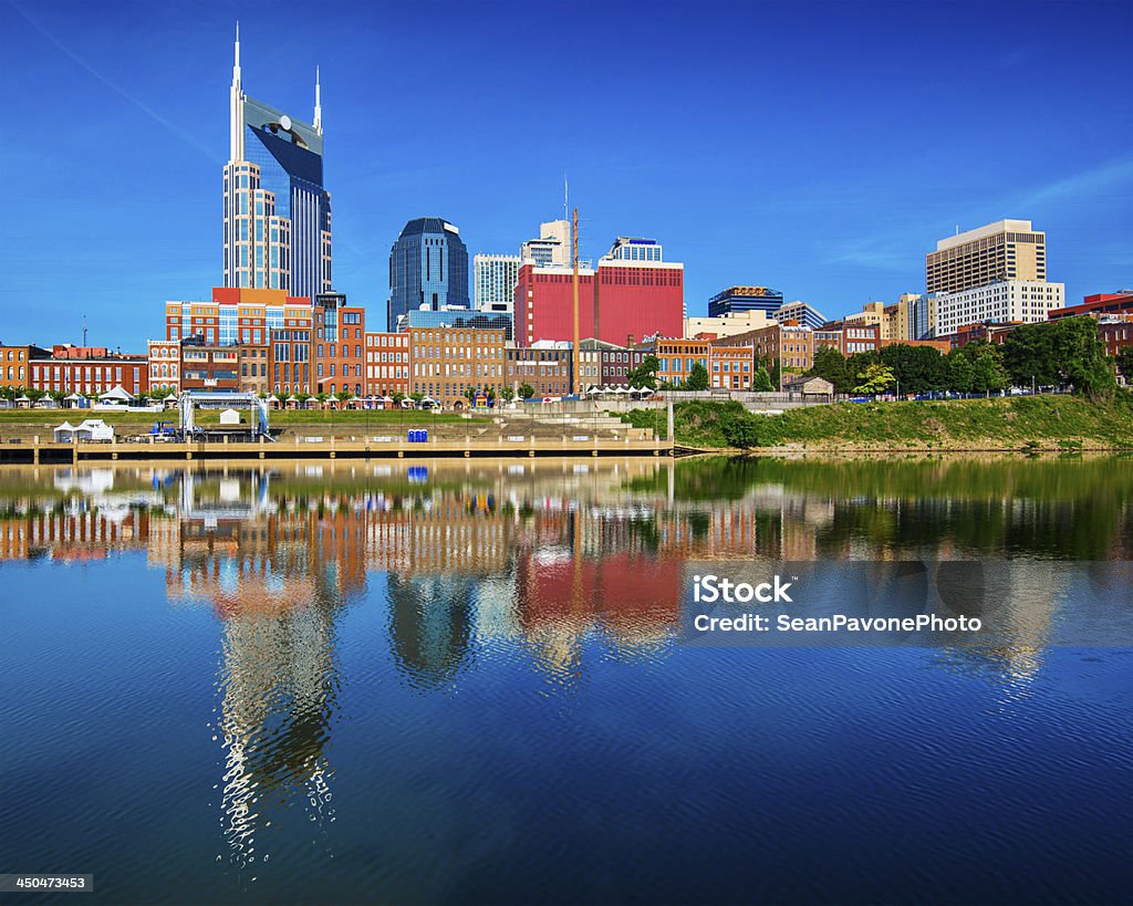 Pristine buildings of Nashville Tennessee reflected in water Nashville, Tennessee downtown skyline at Cumberland River. Nashville Stock Photo