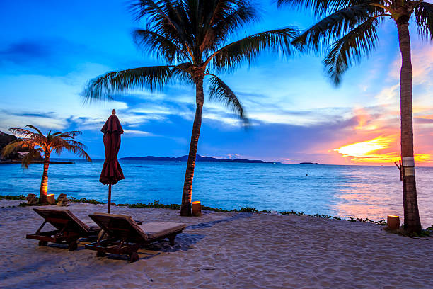 istock Beach chairs and umbrella, set up to view the sunset 450482441