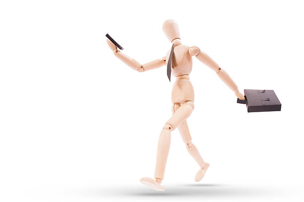 istock bussiness man running looking to his cellphone with clipping path 450485171