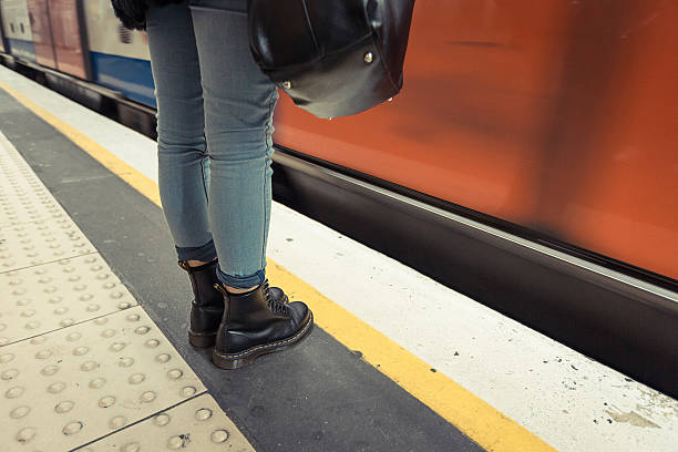 istock Woman Wearing Boots Waiting for Metro Train 450516159
