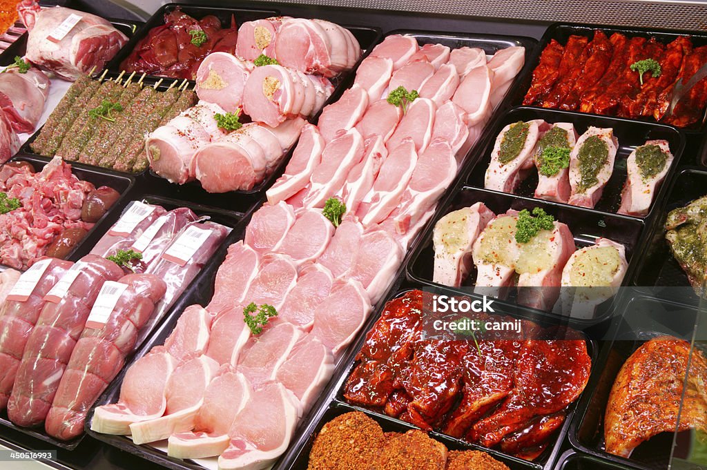 Pork Display in Butcher Shop A selection of pork on display in a butchers shop Butcher's Shop Stock Photo