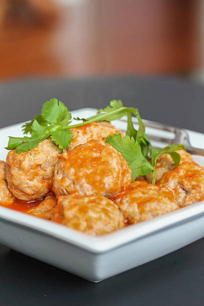 istock Pork dumpling balls in tomato sauce served with bread 450518051