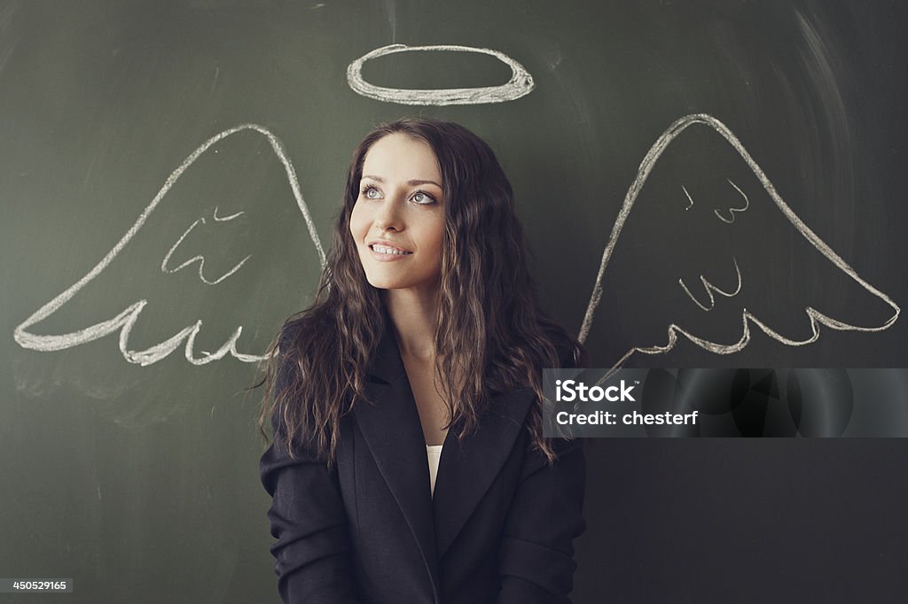 girl over chalkboard with funny picture girl over chalkboard with funny angel wings and nimbus Adult Stock Photo