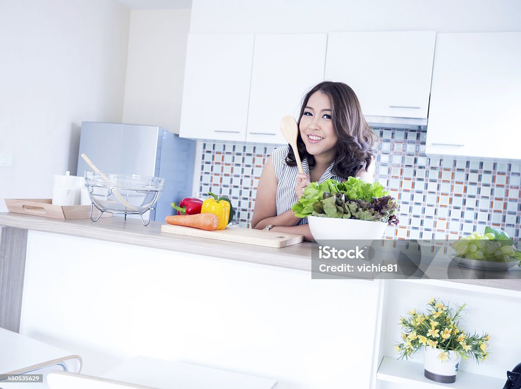 Woman relax in kitchen Portrait of beautiful relaxed young woman standing at the kitchen counter Adult Stock Photo