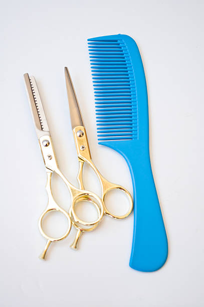 istock Blue comb and golden scissor 450540219