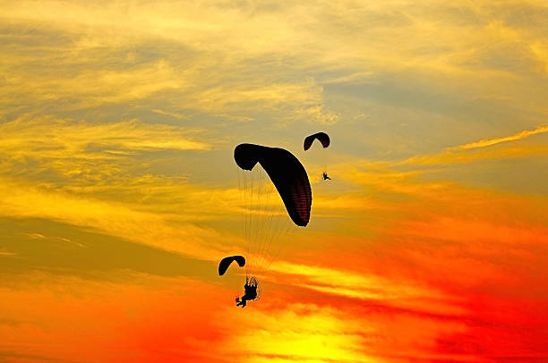 Paramotor Paramotor with sundown background para ascending stock pictures, royalty-free photos & images