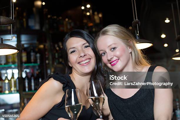 Two Female Friends Toasting In A Nightclub Stock Photo - Download Image Now - Adult, Alcohol Abuse, Beautiful People