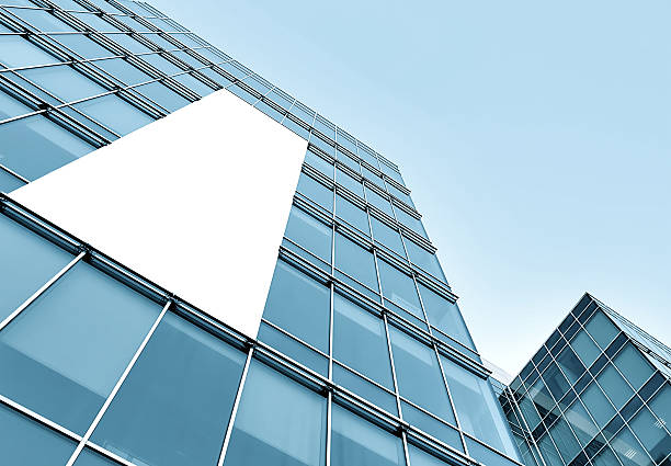istock blue glass wall with blank placard of skyscraper 450546291