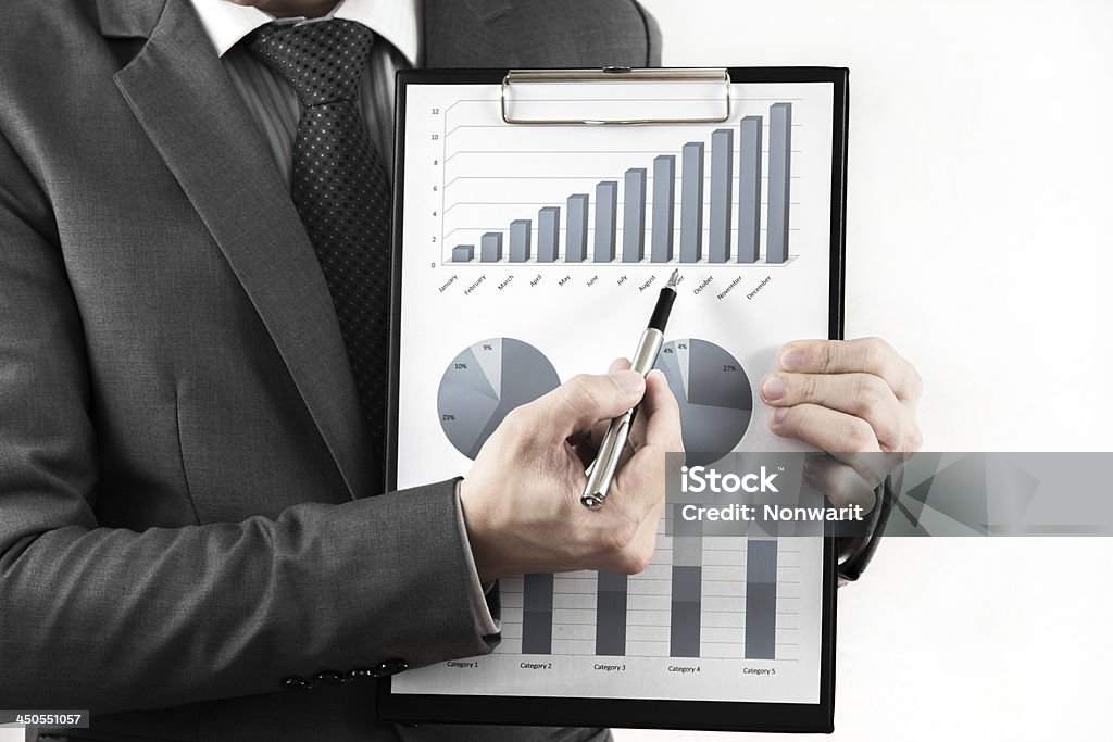 Businessman showing a positive graph Businessman showing a positive graph. isolated on white Adult Stock Photo