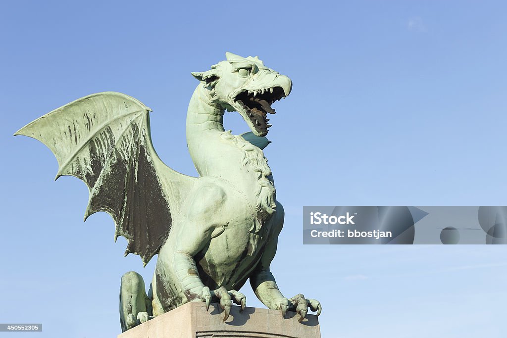 Green dragon statue Dragon statue in Ljubljana, Slovenia. Dragon is the symbol of the city. Statue is part of a bridge built in 1901. Animal Body Part Stock Photo