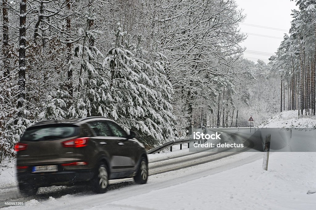 Traffic on a wintry road Car SUV on a wintry road. Germany, Brandenburg Car Stock Photo