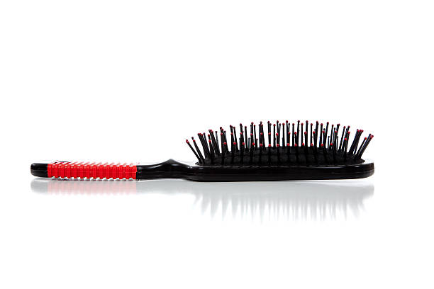 istock Red and black hair brush on white 450577651
