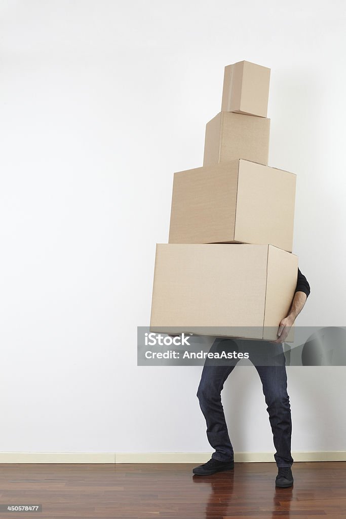 Man lifting cardboard boxes, moving day Man lifting cardboard boxes in apartment, moving day Carrying Stock Photo