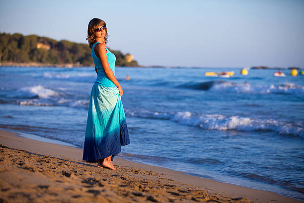 Girl in blue near the sea stock photo