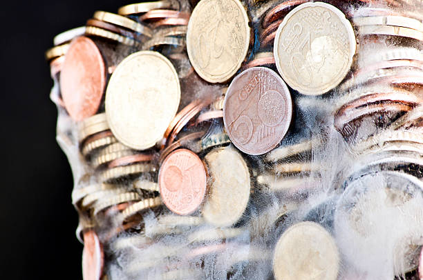 istock Shiny euro coins frozen in ice 450583177