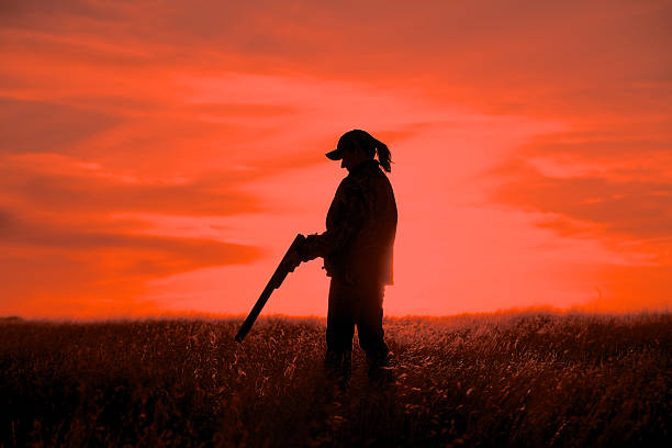 istock Woman Bird Hunter in Sunset 450596783