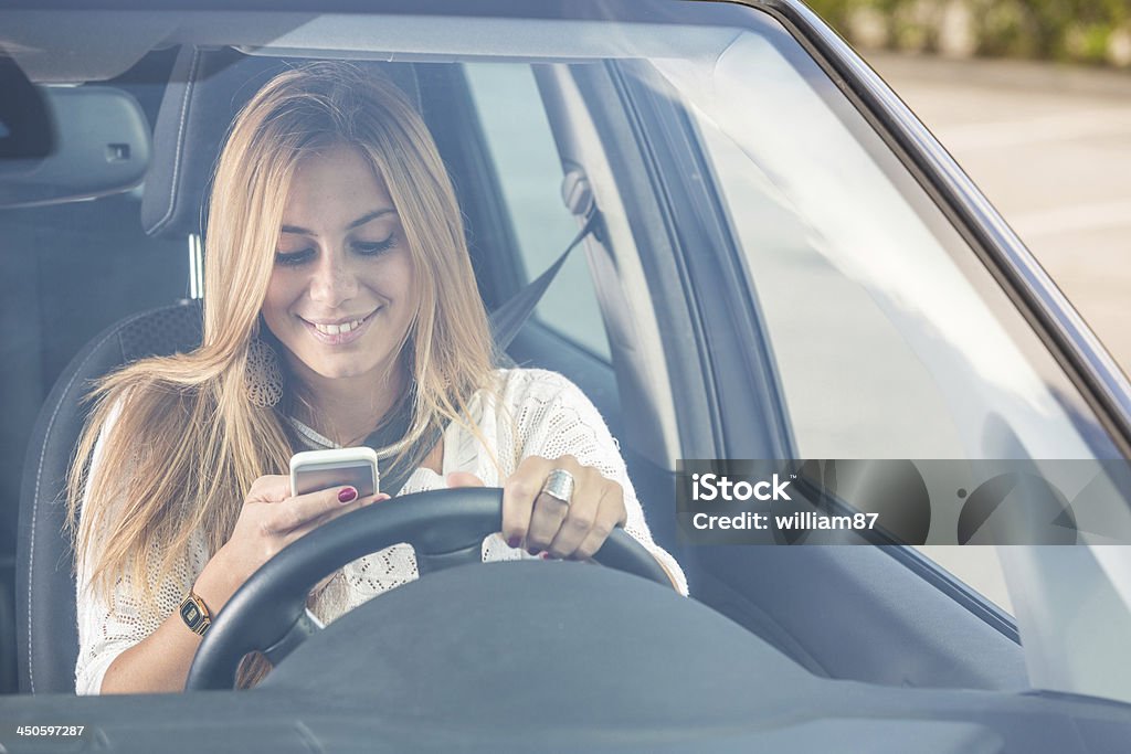 Young Woman Sending Messages while Driving Communication Stock Photo