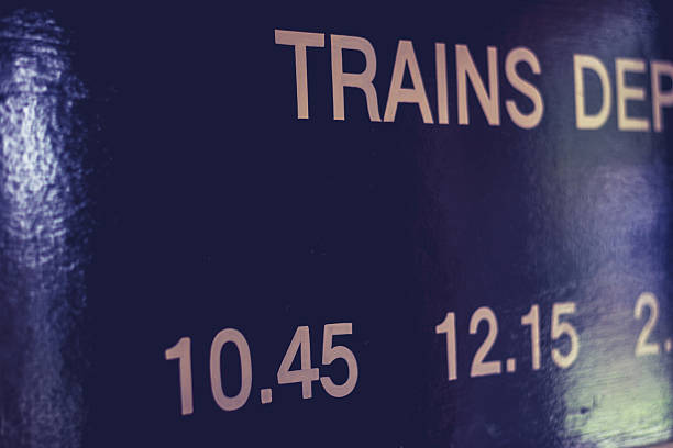 istock Train times on wooden board 450597363