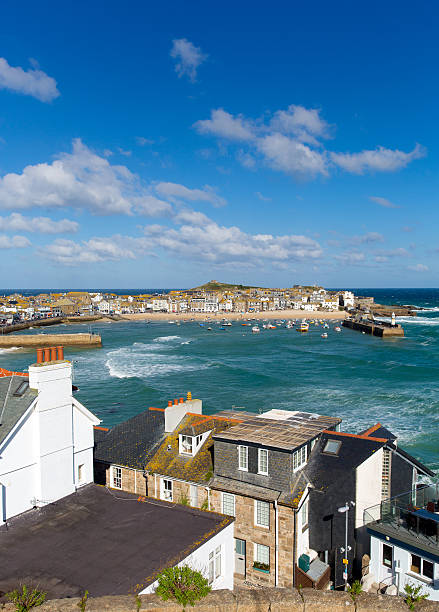 View of St Ives Cornwall England with harbour, boats and blue sea and sky, a traditional Cornish fishing town in the UK