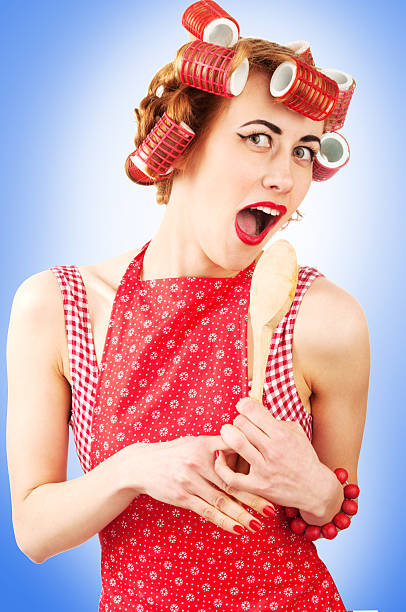 istock Young housewife singing with spoon 450603309