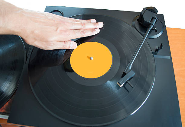 DJ mixing DJ mixing vinyl record on a  turntable with hand dubstep photos stock pictures, royalty-free photos & images