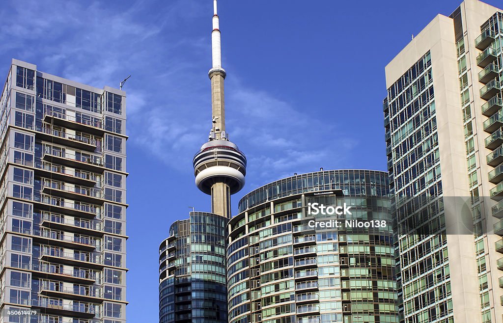 CN Tower and residential buildings against blue sky CN Tower and residential buildings against blue sky, Toronto, Ontario, Canada Apartment Stock Photo