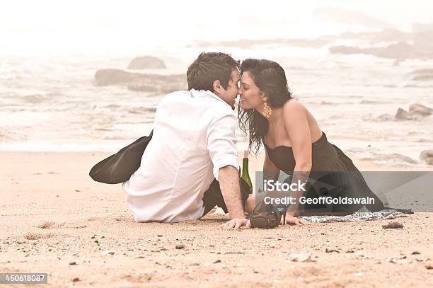 Young Attractive Couple Sitting Together On Misty Beach Stock Photo - Download Image Now