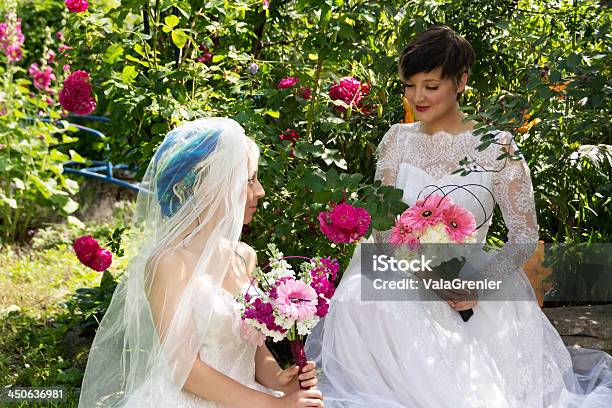Dwa Uśmiechnięte Brides Siedzi W Ogrodzie Różanym - zdjęcia stockowe i więcej obrazów 20-24 lata - 20-24 lata, 20-29 lat, Brązowe włosy