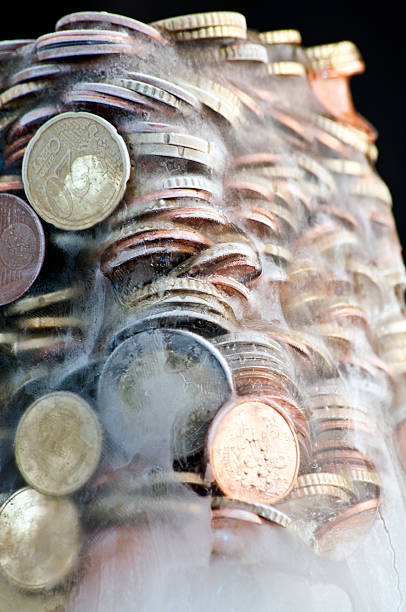 istock Shiny euro coins frozen in ice 450642597