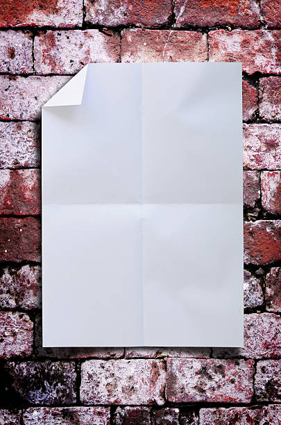 istock White wrinkled paper with red brick wall 450644345