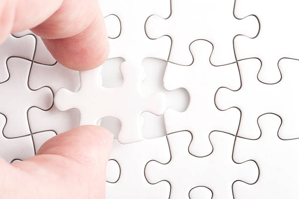 istock Hand holding the last piece of jigsaw puzzle 450645497