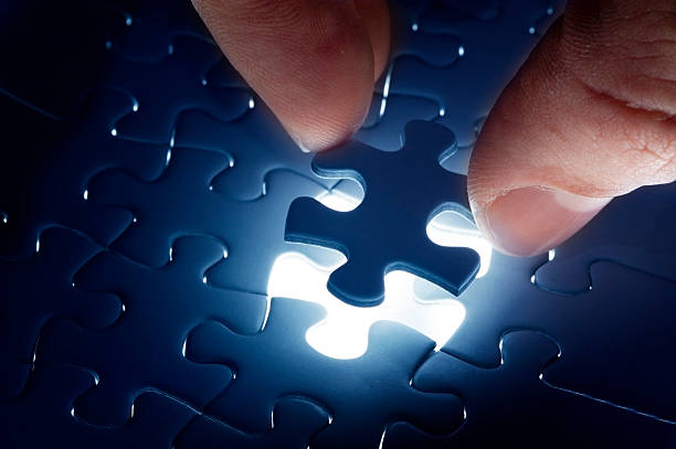 istock Hand holding the last piece of jigsaw puzzle 450645705